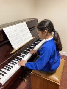 A child playing an upright piano